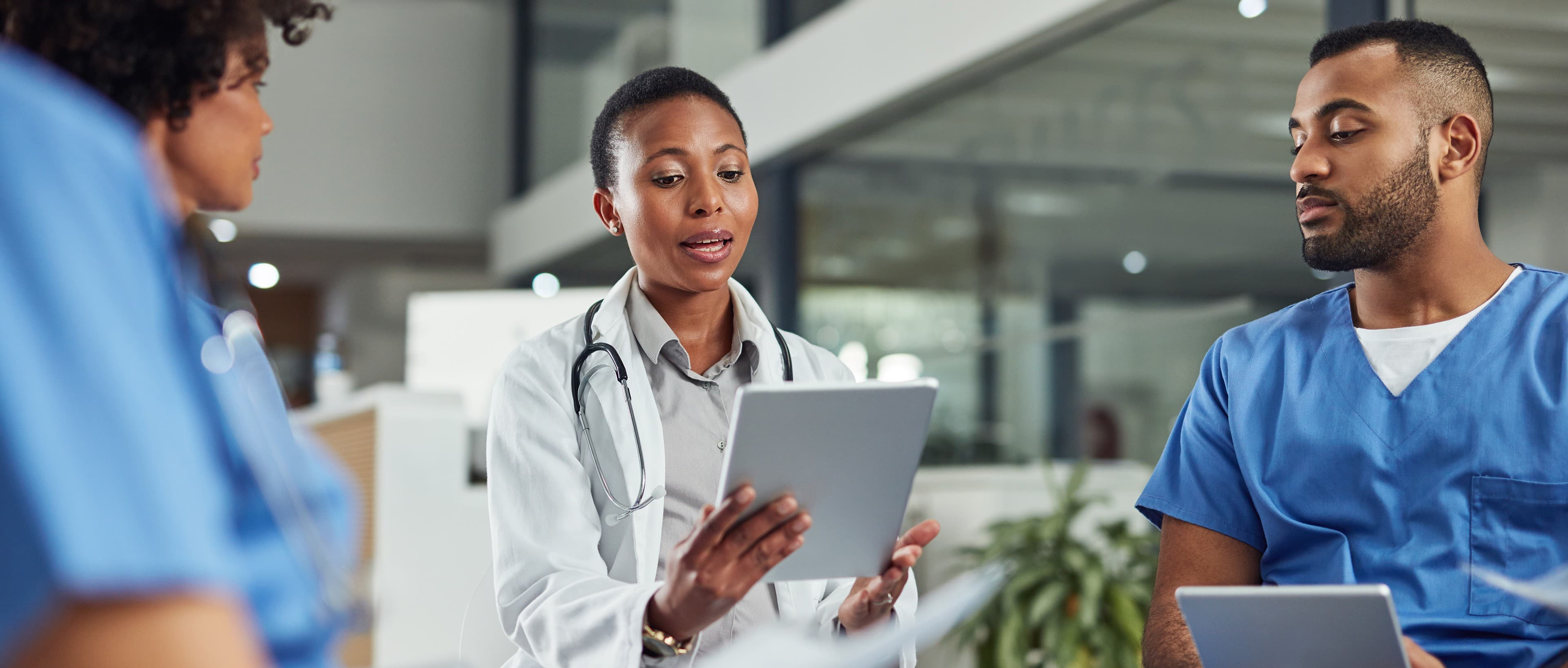 Healthcare practitioners discussing care together in a hospital